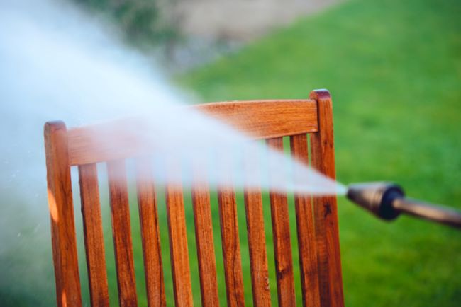 using a power washer to clean old wooden furniture