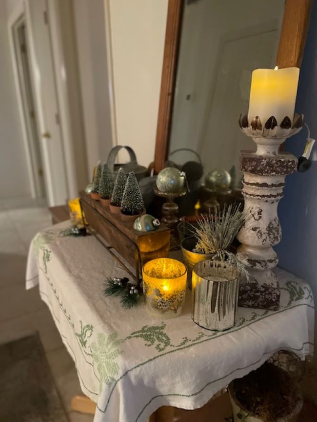 hallway table with sugar mold holding bottle brush trees and vintage ornaments