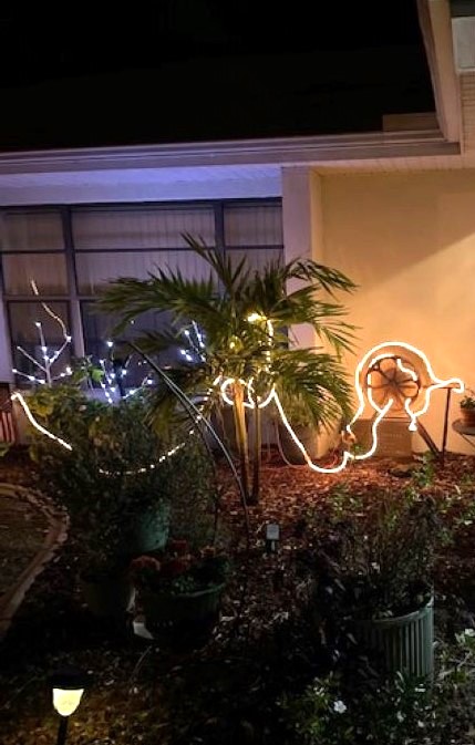 outdoor holiday lights decorating an old grindstone