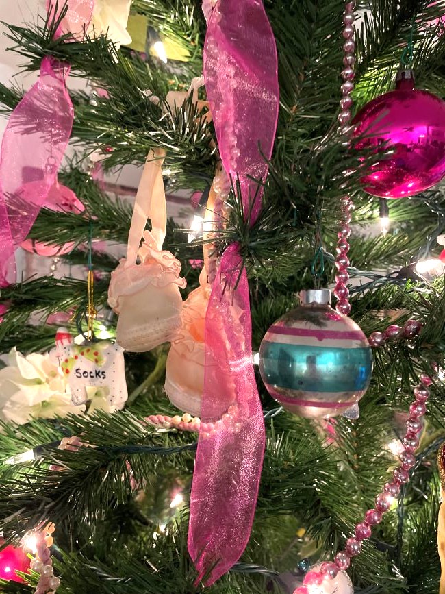 pair of vintage baby shoes hanging in a Christmas tree