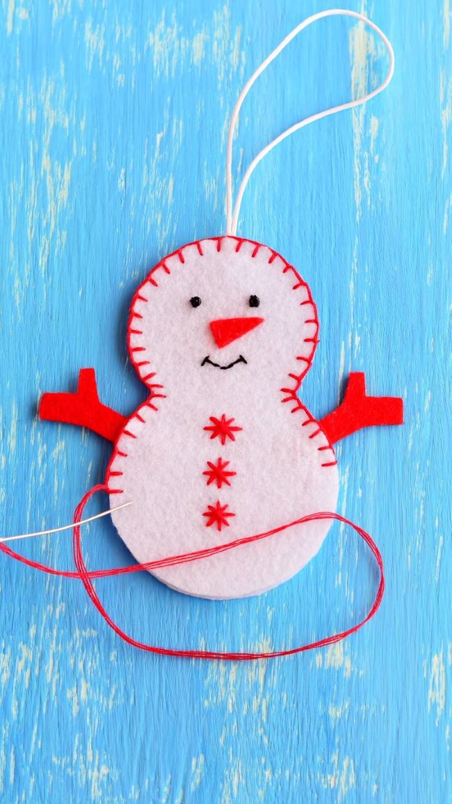 Stitching the snowman ornament together