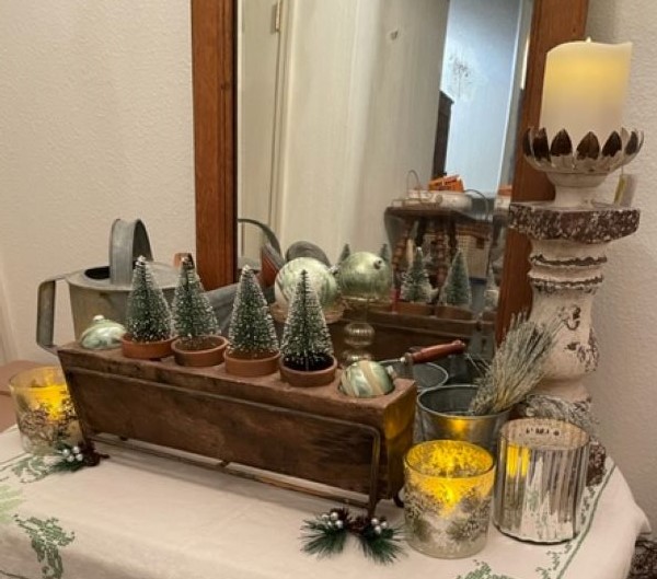 hallway table with winter display. Sugar mold, bottle brush trees and battery candles