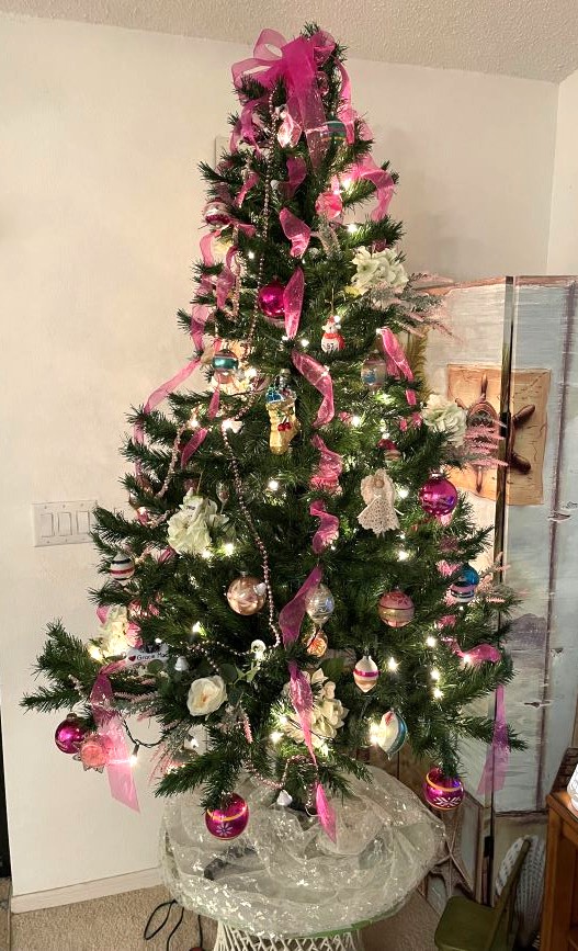 Christmas tree decorated with vintage ornaments, silk flowers, ribbon and beaded garland