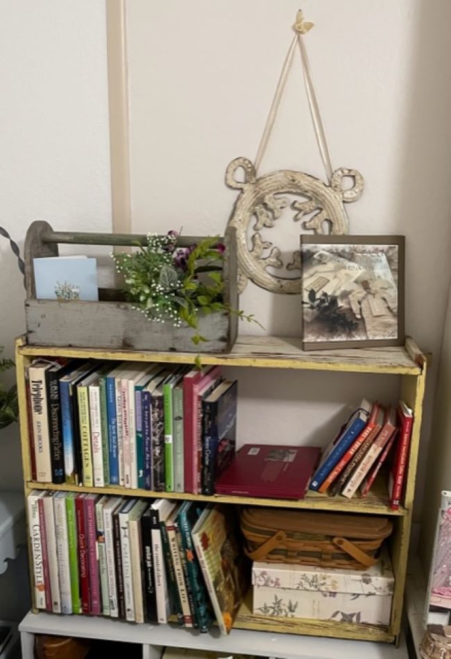 small yellow bookshelf filled with books