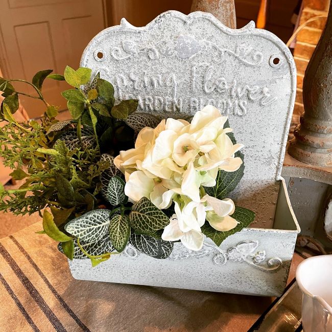 Spring arrangement of white hydrangea and greenery