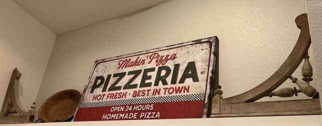 vintage corbels next to a pizza sign