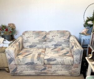 loveseat with outdated upholstery
