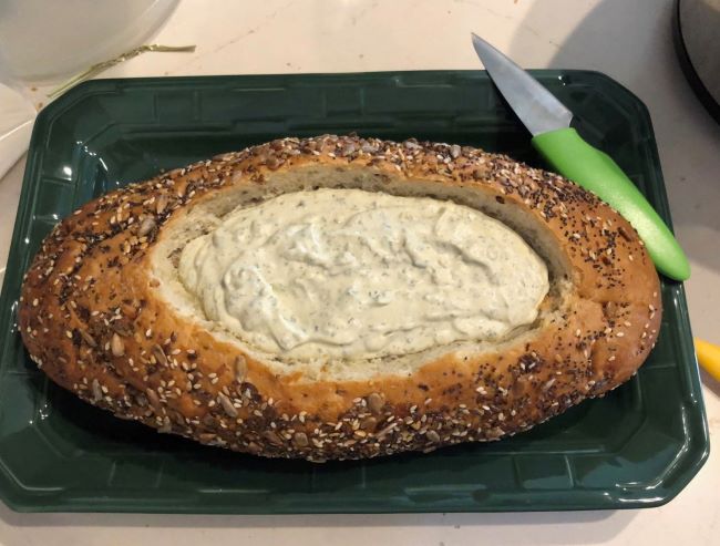 Artisan bread loaf made into a bowl. Filled with Dillicious Spinach Dp