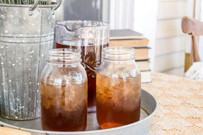 two glass Mason jars full of iced tea