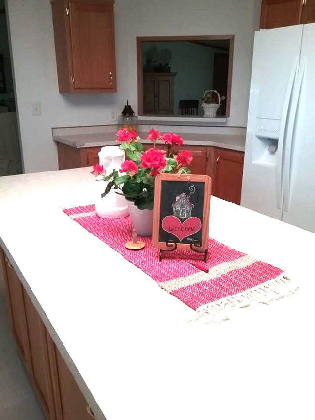kitchen island with geranium and small chalkboard