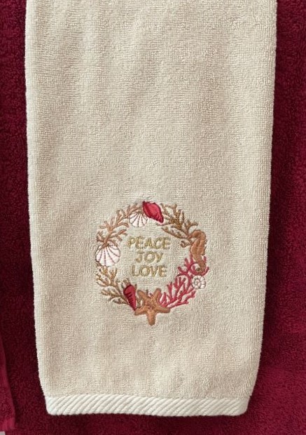 cream colored hand towel with shell theme. Peace Joy Love embroidery