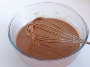 chocolate cake batter in glass bowl