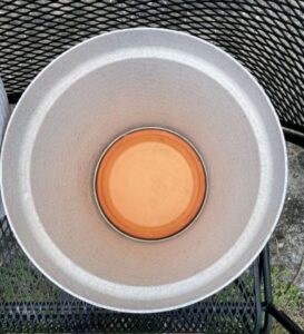 terra cotta saucer inside an eco friendly container