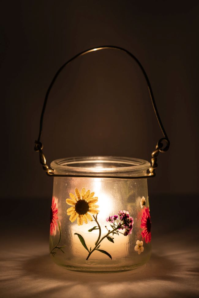 small glass jar with hand painted flowers. Designed to be a hanging lantern