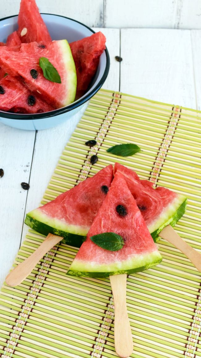 easy to eat slices of watermelon on a wooden stick