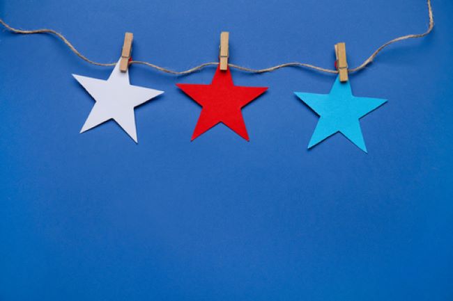 star shapes cut out of construction paper and hanging on twine