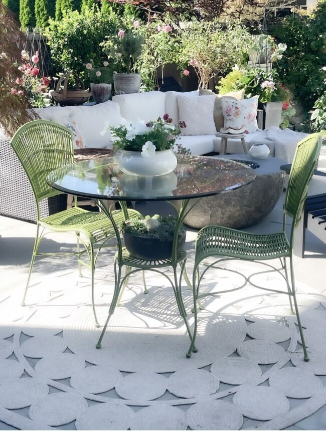 serene patio with celadon garden chairs, white sofa and assorted containers
