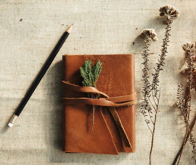leather bound journal on a burlap background