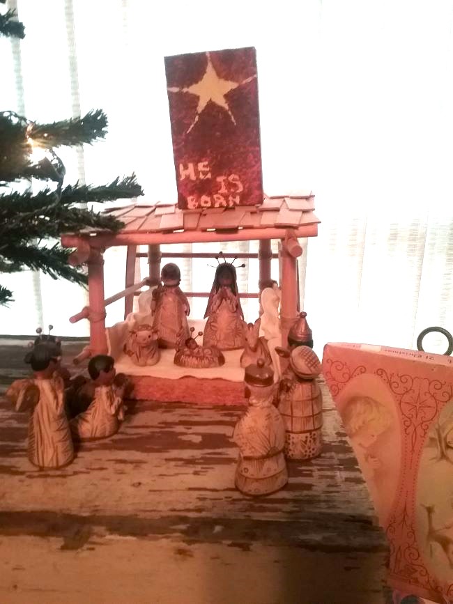 nativity scene next to a small tree