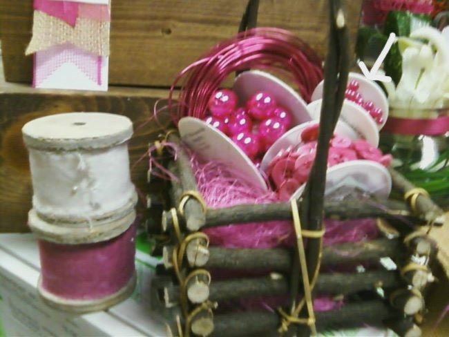 basket of hot pink Oasis products . White arrow pointing to hot pink beaded wire