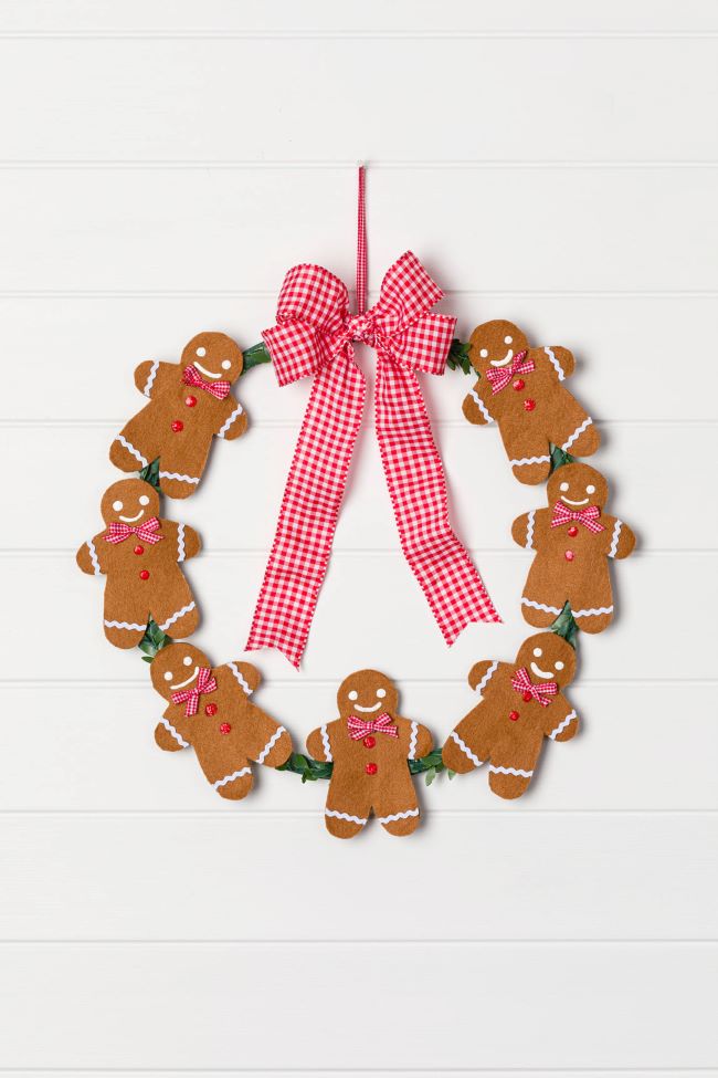 Holiday wreath with gingerbread men and a red gingham bow