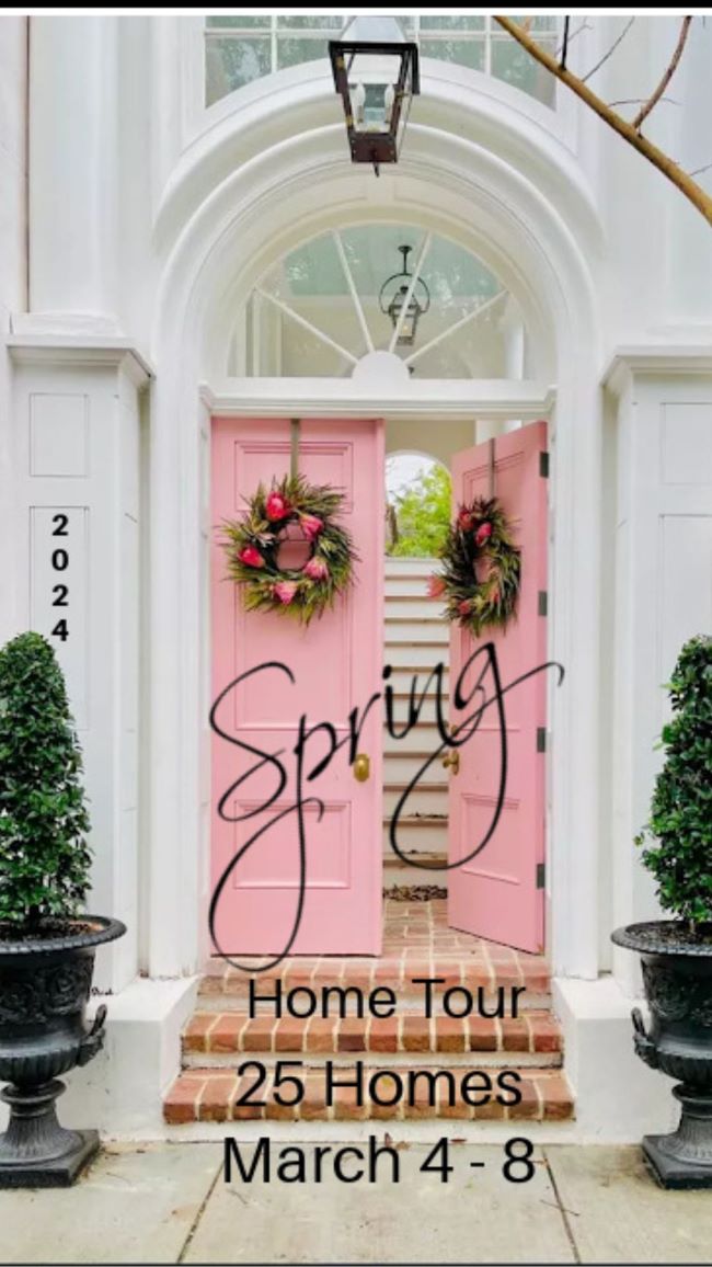Pink wooden front door with pink wreaths.