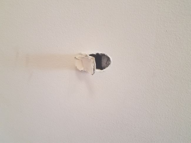 hole in drywall wall caused by scraping too hard