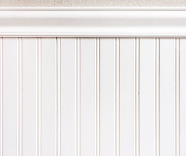 close up of white wainscoting or beadboard on wall