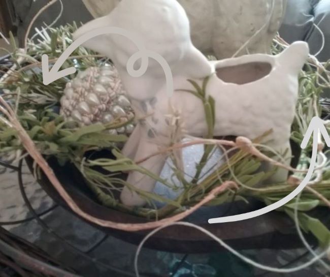 wispy wreath lining a wooden bowl accented with ceramic vintage lamb planter