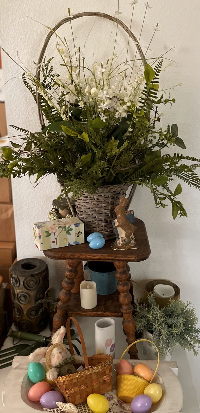 old wicker basket filled with faux flowers, focal point of vintage inspired Easter display