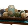 long wooden dough bowl filled with shells and glass balls