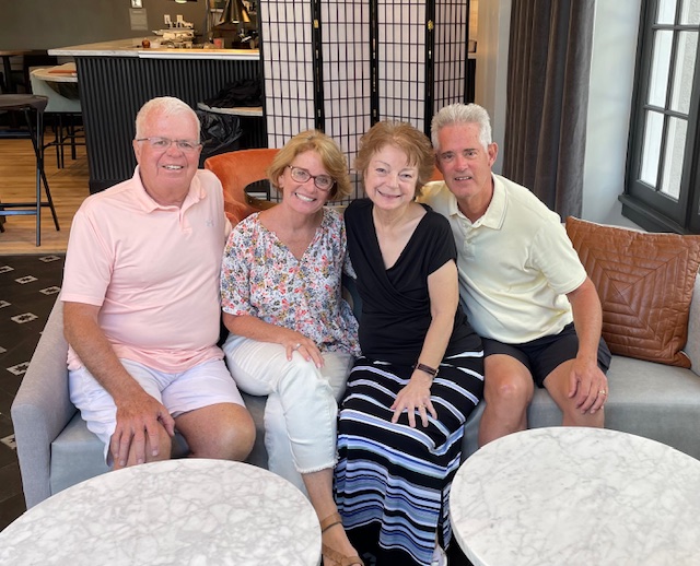 two couples sitting on a couch