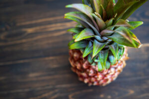 overhead view of a pineapple on a wooden table