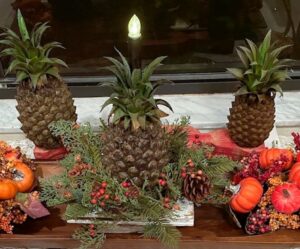 battery operated candle in a faux fruit dough bowl arrangement