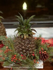 close up of artificial pineapple with a battery candle