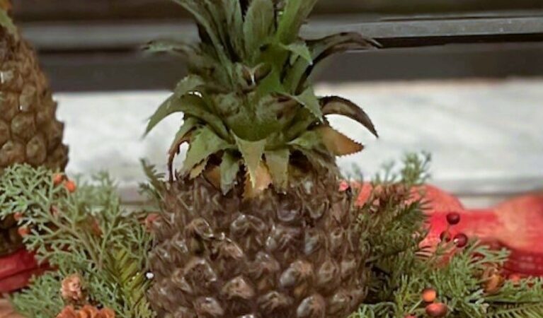 close up of artificial pineapple with a battery candle