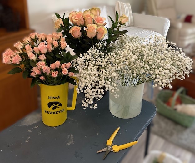 roses and babies breath in containers