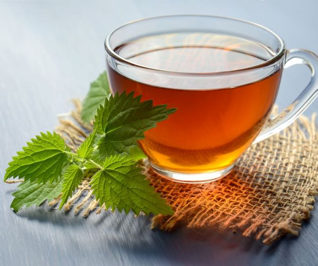 clear glass of tea with a sprig of mint