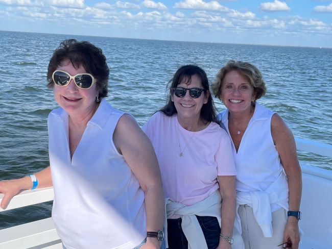 three friends enjoying a boat cruise