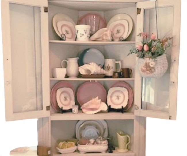 corner cabinet decorated with pink and cream