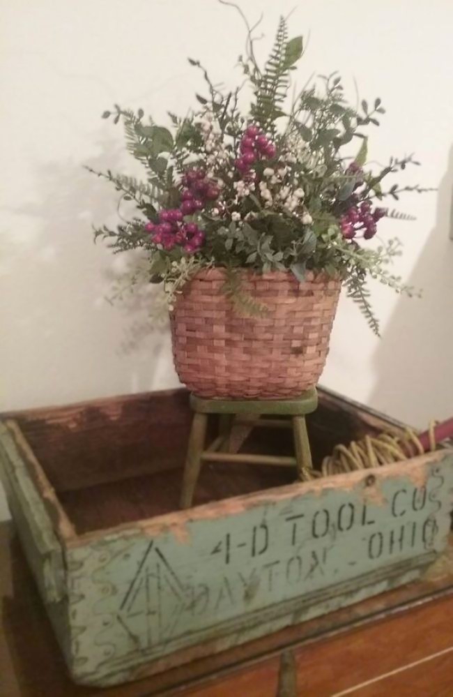 red berry themed silk arrangement in old wooden box
