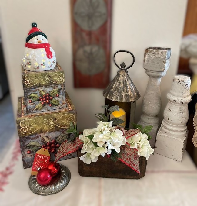 three hole sugar mold decorated with silk hydrangea, holiday ribbon and a greenery pick