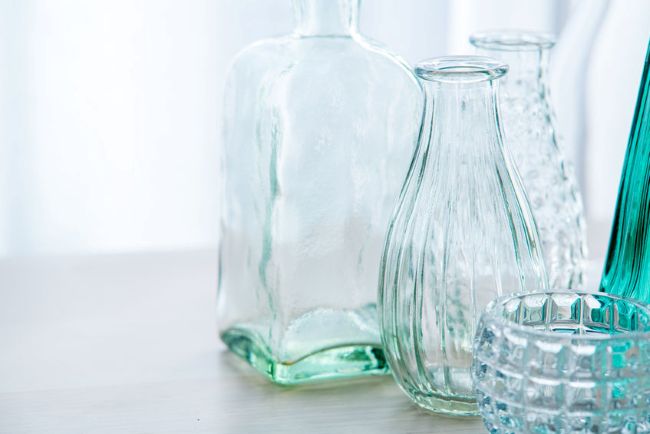 an assortment of glass budvases