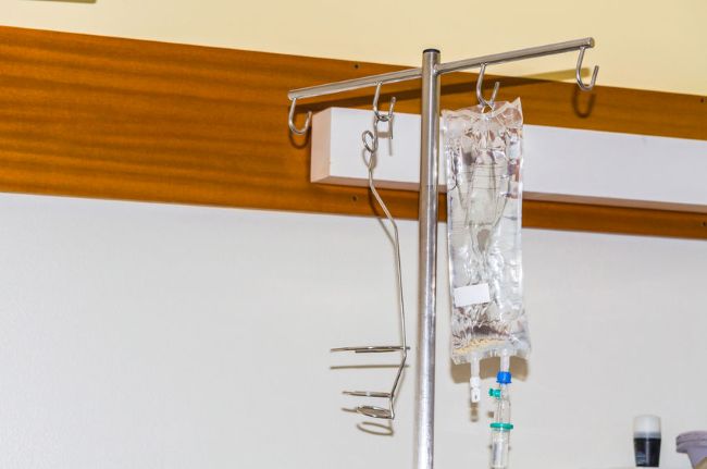 iv pole with a bag of saline hanging on it