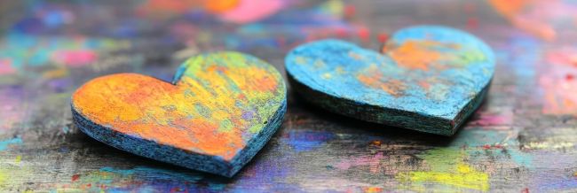 pastel wooden hearts on a multicolored background