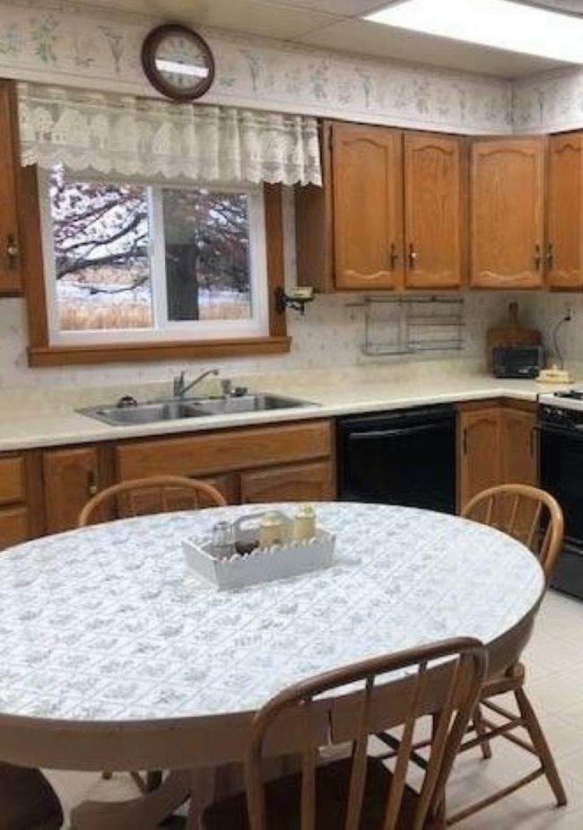 kitchen table in farmhouse kitchen with lace curtains