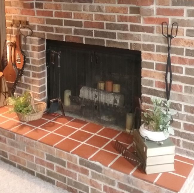 hearth area of fireplace with basket and books