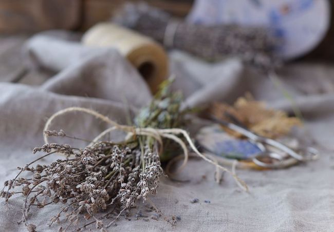 dried lavender bundle tied with twin on muslin table cloth