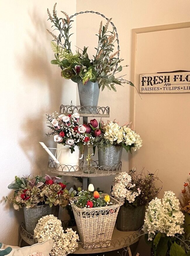 vintage style corner wire rack filled with buckets of faux flowers
