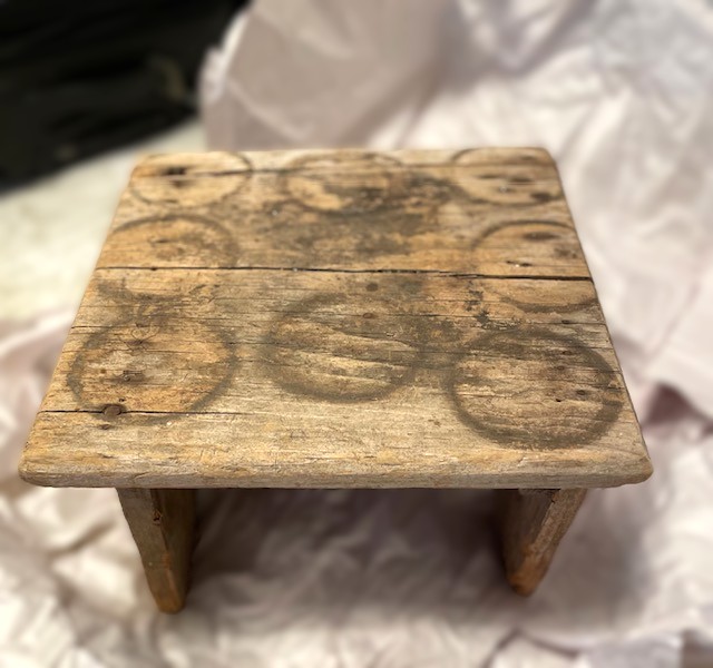 old wooden stool with a distressed top